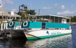 boat with aqua colors and canopy at marina dock at adventures in paradise fort myers