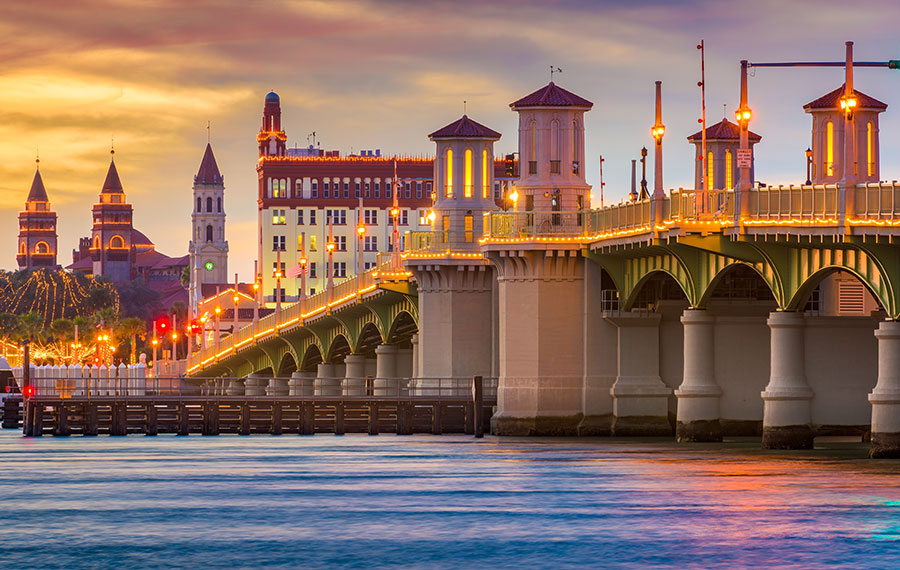 bridge of lions at sunset with long exposure and hotels in background st augustine