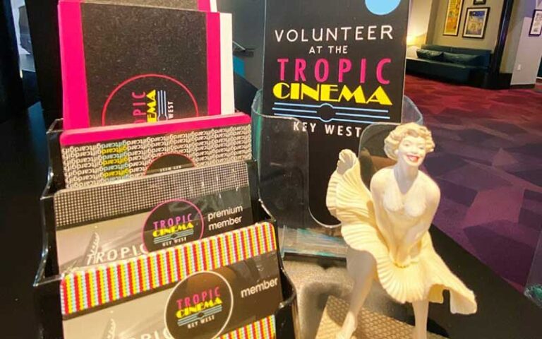 brochures and gift cards with monroe statue on countertop at tropic cinema key west