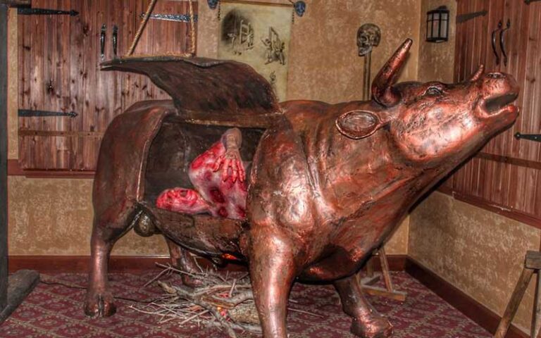cast bronze bull oven with door and victim inside at medieval torture museum st augustine