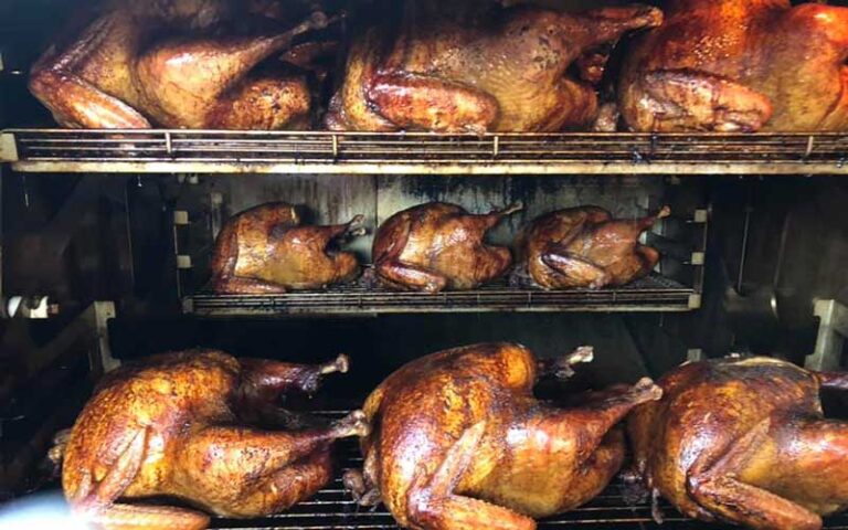 chickens roasting in barbecue over racks at woodpeckers backyard bbq st augustine