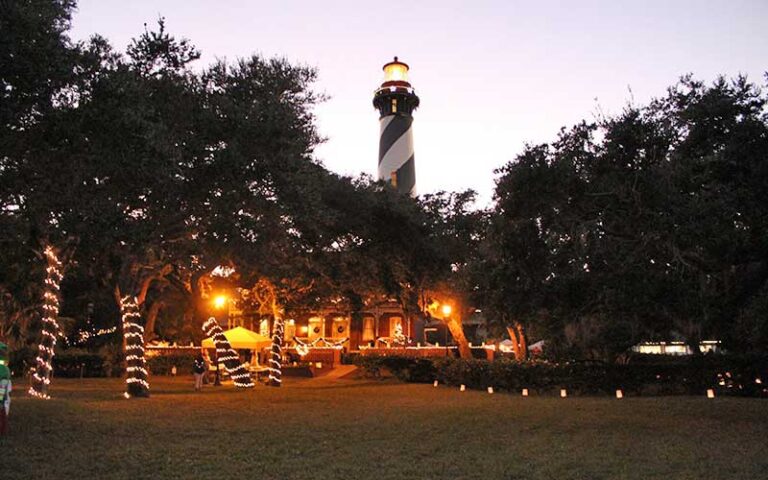 christmas lighted trees and tower at night at st augustine lighthouse maritime museum