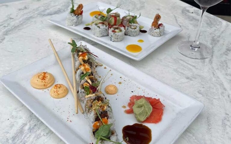 colorful sushi platters on white table with wine glass at the firestone fort myers