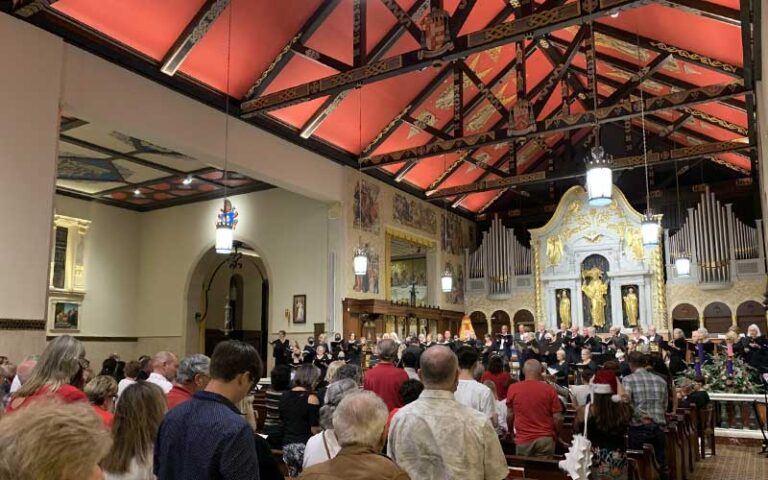 congregation with red ceiling and rafters at cathedral basilica of st augustine