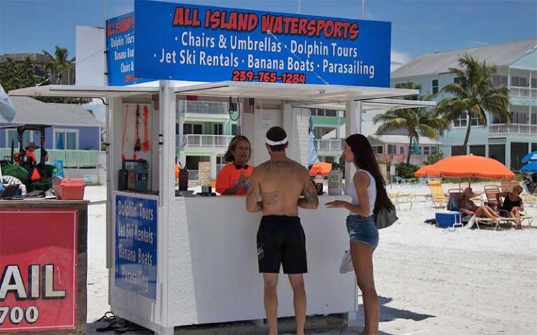 couple at stand renting jet skis at all island watersports fort myers beach