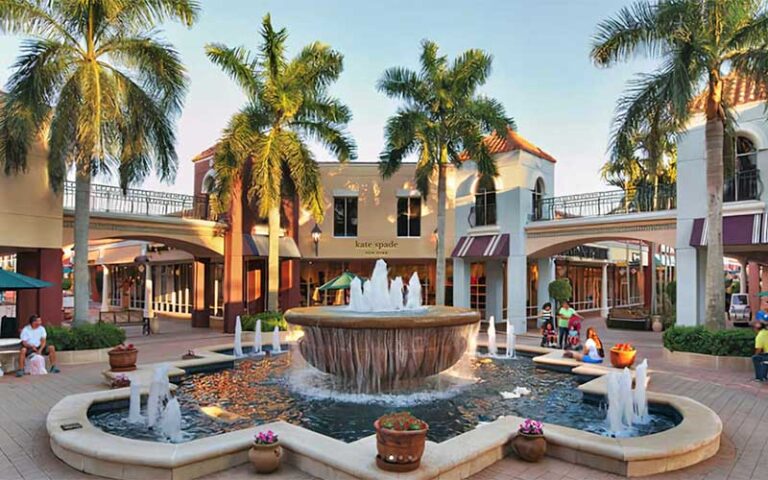 courtyard of shopping plaza with fountain and palms at miromar outlets fort myers
