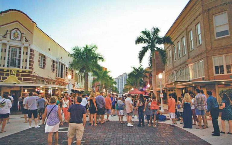 crowds on street with historic buildings at fort myers river district