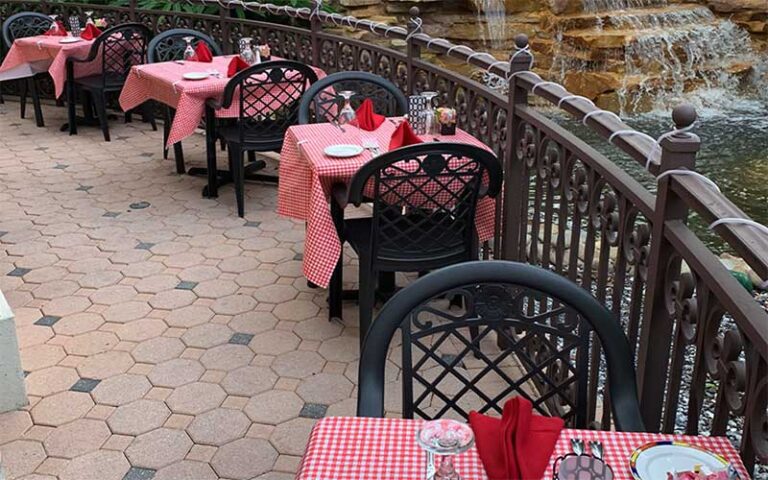 dining space with tables and chairs on balcony next to fountain area at promenade at bonita bay fort myers