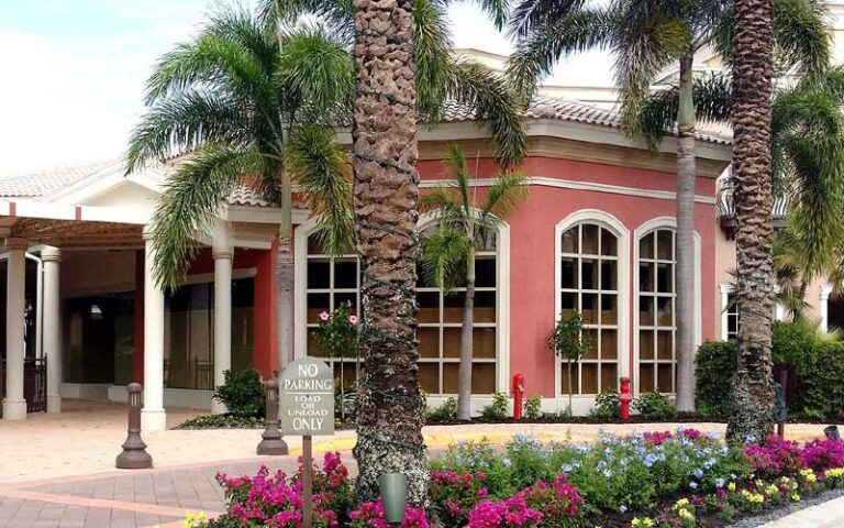 event area with palms and coral colored patio at promenade at bonita bay fort myers