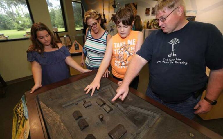 family looking at exhibits of old fort at fort mose state park st augustine