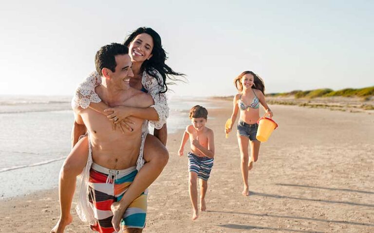 family of four running on beach at st augustine beach