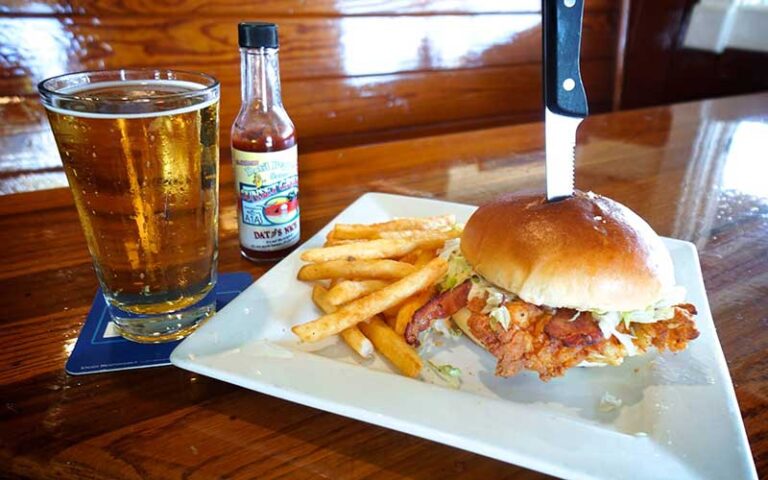 fish sandwich plate and pint glass beer at sunset grille st augustine beach