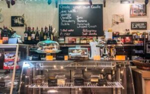 front counter of cafe with desserts in case at gaufres and goods st augustine