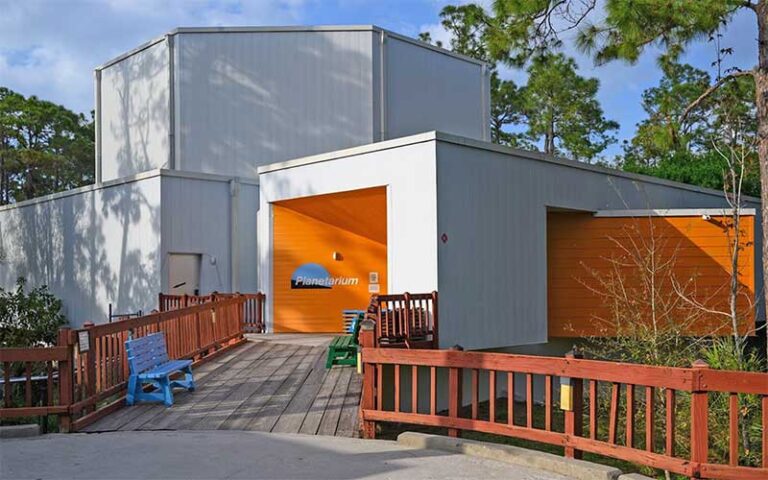 front entrance white building with orange inner wall at calusa nature center planetarium fort myers