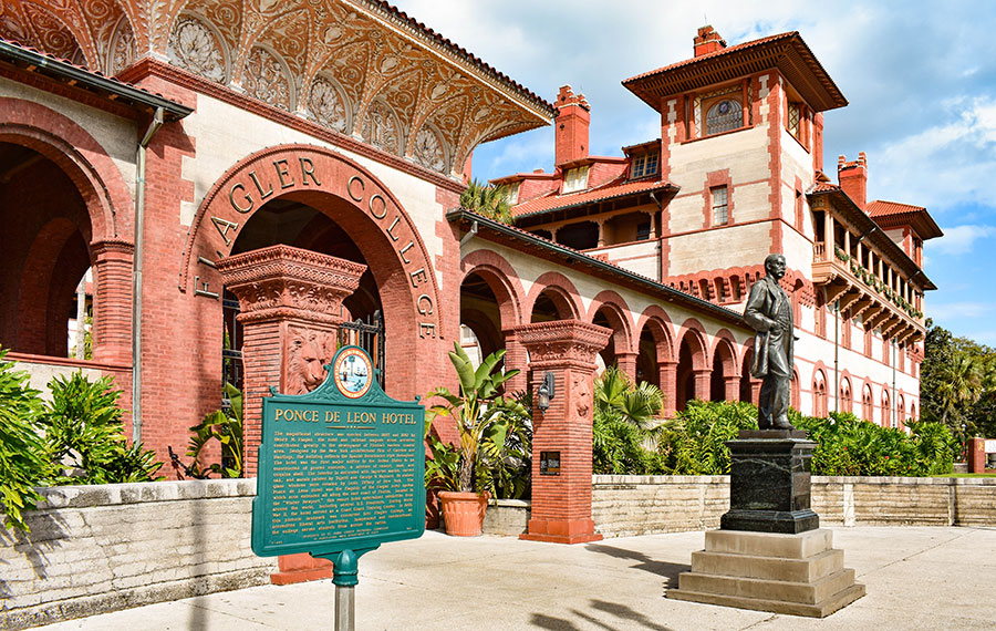 front exterior with courtyard and statue of flagler college buildings with arched verandas st augustine