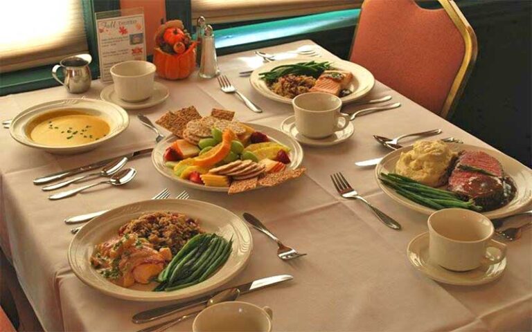 fully set dinner table with different selections at murder mystery dinner train fort myers