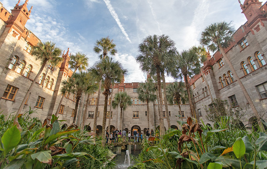 garden area courtyard with tall palms bridge and fountain alcazar lightner museum st augustine