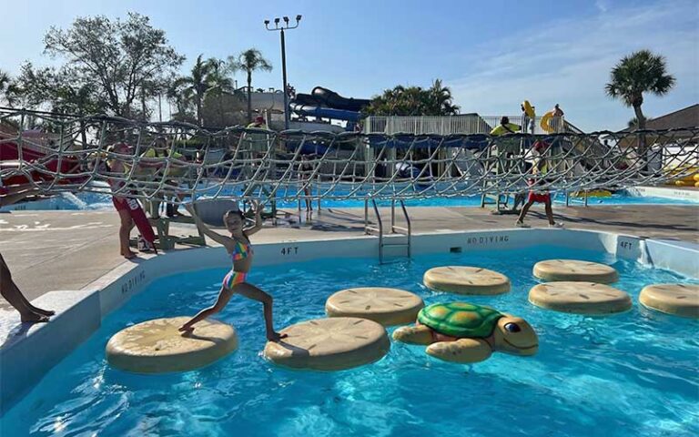 girl crossing obstacle course over pool at sun splash family waterpark fort myers