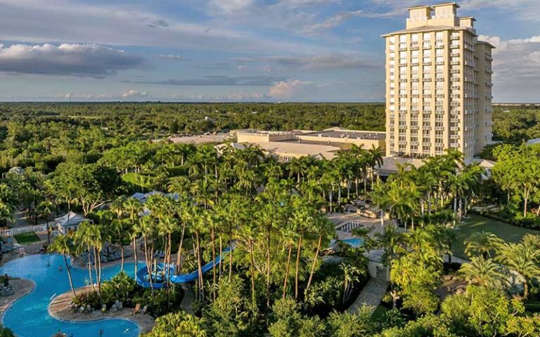high rise hotel with trees and lazy river pool at hyatt regency coconut point resort spa fort myers