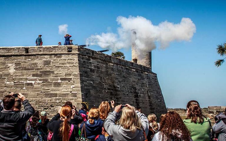 historic reenactment cannon firing with smoke at castillo de san marcos st augustine