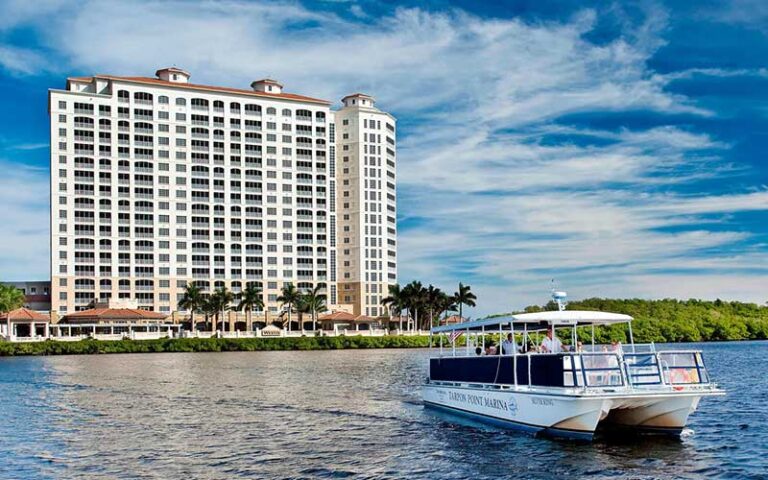 hotel along bank with tour boat moving away at the westin cape coral resort at marina village fort myers