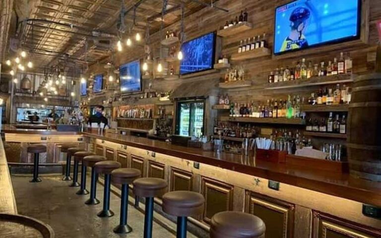 interior of pub with long bar and stools at prohibition kitchen st augustine