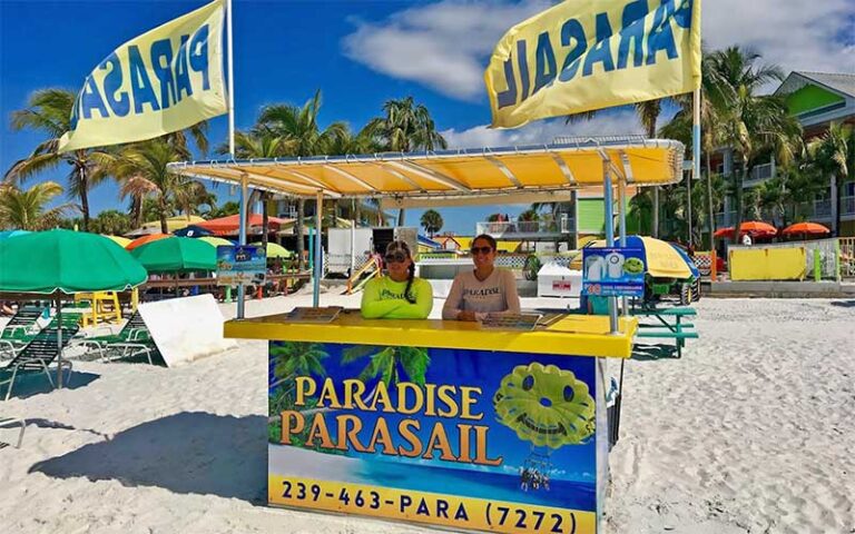 ladies at stand on beach at paradise parasail fort myers beach