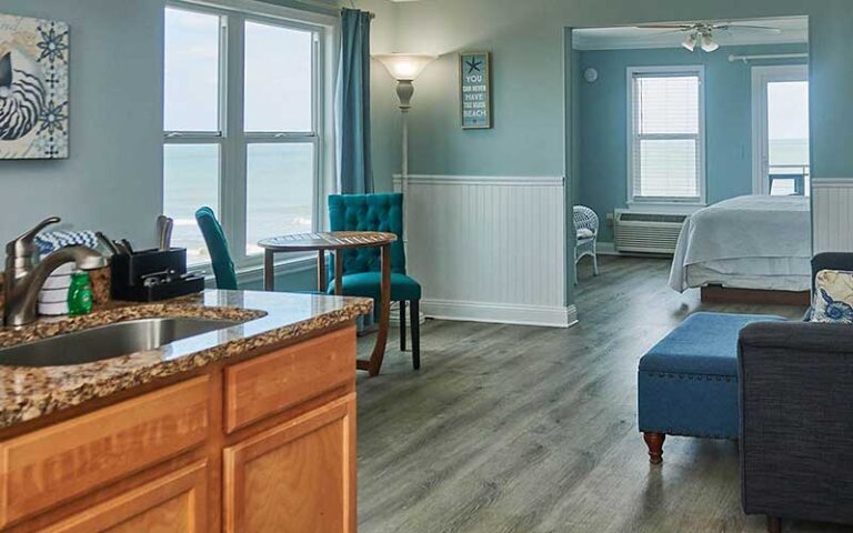 large suite with kitchenette beds chairs and view of beach at st augustine beach house vilano