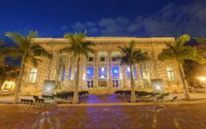 lighted front exterior with event seating at night at sidney and berne davis art center fort myers