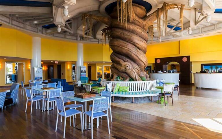 lobby dining area with tree trunk pillar at pink shell beach resort marina fort myers