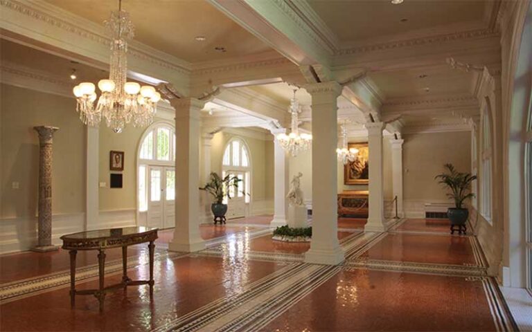 luxurious room with columns wood floors and chandeliers at lightner museum st augustine