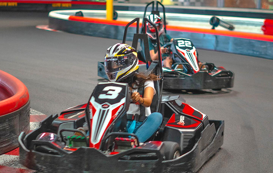 man and woman racing go karts on track k1 speed indoor karting miami