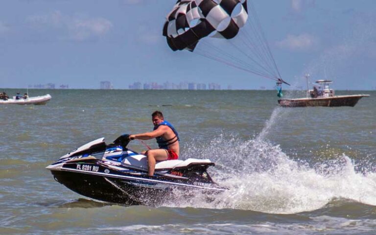 man jetskiing with parasail behind at all island watersports fort myers beach
