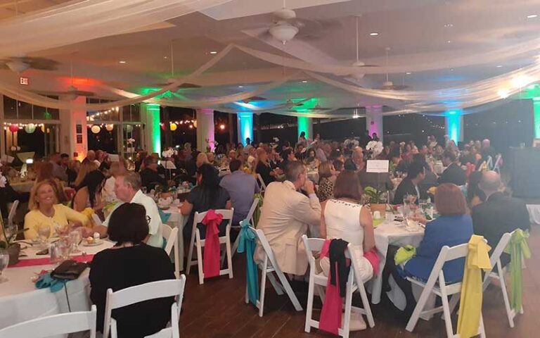 multicolored reception in outdoor pavilion with crowded tables at burroughs home and gardens fort myers