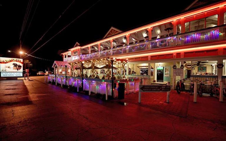 night exterior of two story restaurant with lighted sign at sunset grille st augustine beach