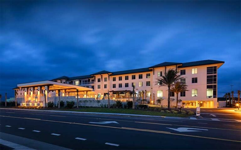 night view of lit up exterior from road at embassy suites st augustine beach