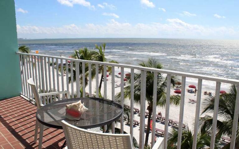 ocean view balcony with table and chairs and conch at lana kai island resort fort myers beach
