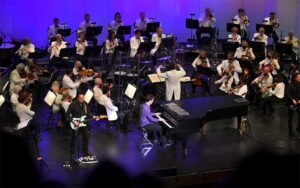 orchestra on stage with pianist and guitarist at gulf coast symphony fort myers