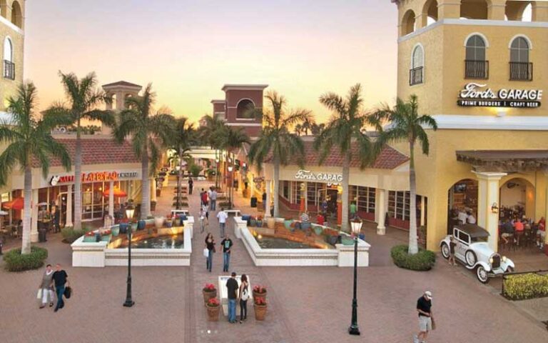 outdoor pavilion with restaurant and line of stores at miromar outlets fort myers