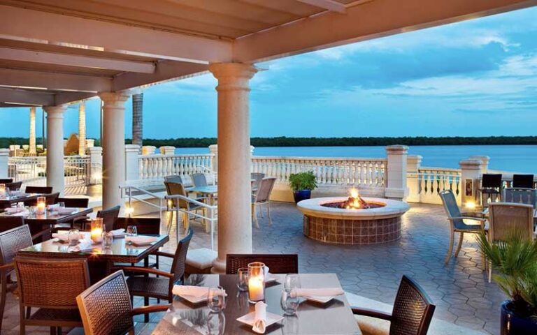 outdoor veranda seating with fire pit and ocean view at the westin cape coral resort at marina village fort myers
