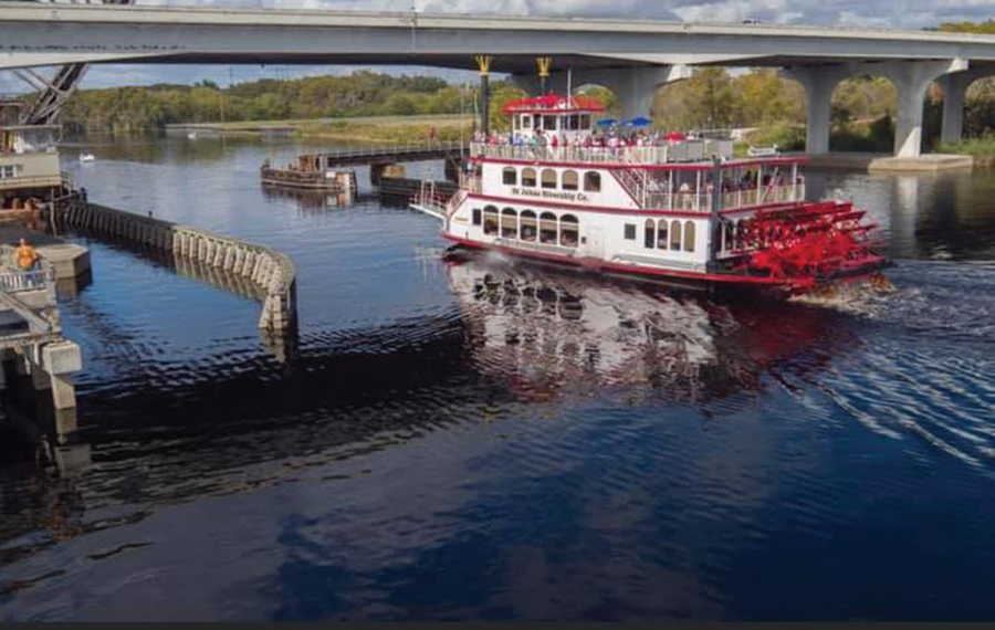 paddlewheel boat on lake moving under bridge st johns rivership cruise