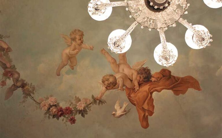 painted domed ceiling with cherubs and chandelier at historic tours of flagler college st augustine
