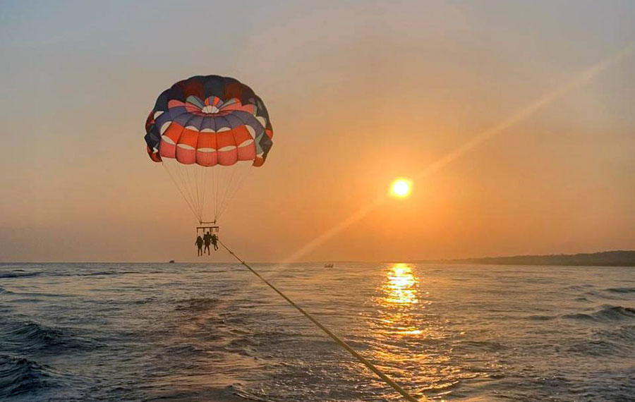 parasailing trio suspended above ocean with sunset view z flight parasail marathon