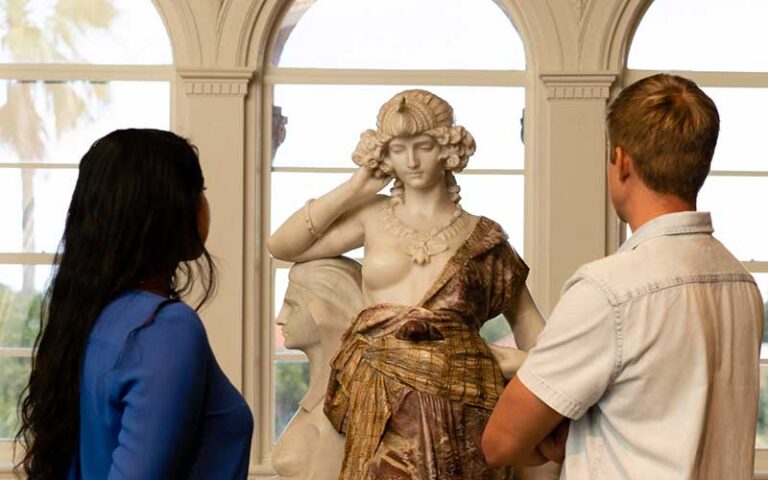patrons looking at sculpture at lightner museum st augustine
