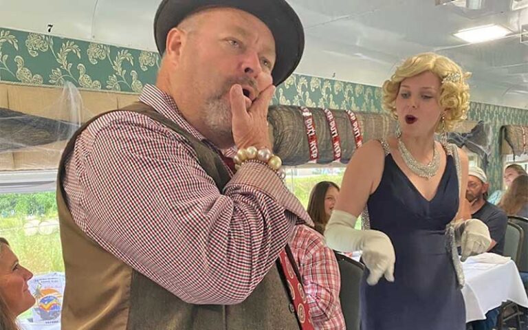performers arguing in dining area of train at murder mystery dinner train fort myers
