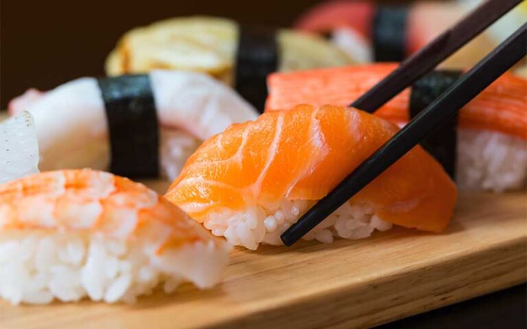pieces of sashimi with chopsticks on board at miromar outlets fort myers