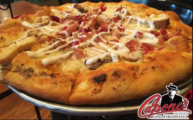 pizza straight from the oven with sauce and chicken at capones coal fire pizza fort myers