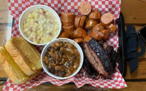 platter of sausage brisket beans and corn at woodpeckers backyard bbq st augustine