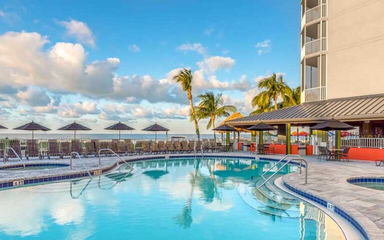 pool area on deck of hotel with cloudy blue sky at diamondhead beach resort fort myers