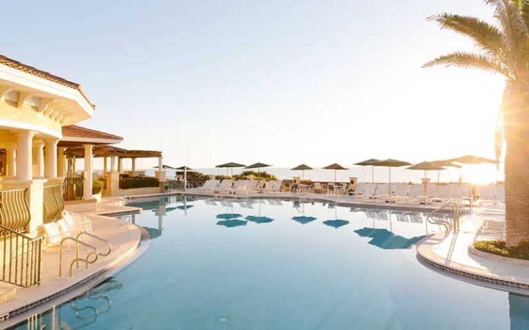 pool area with palm tree low sun and covered patio at casa monica resort spa st augustine